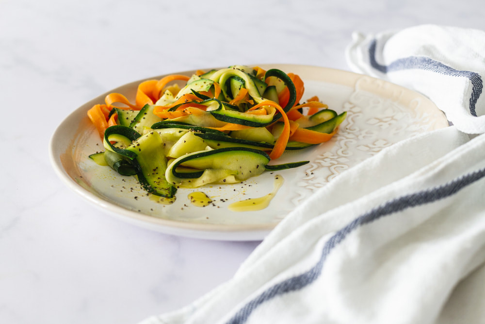 An easy recipe for a summer side dish of carrot and courgette ribbons.