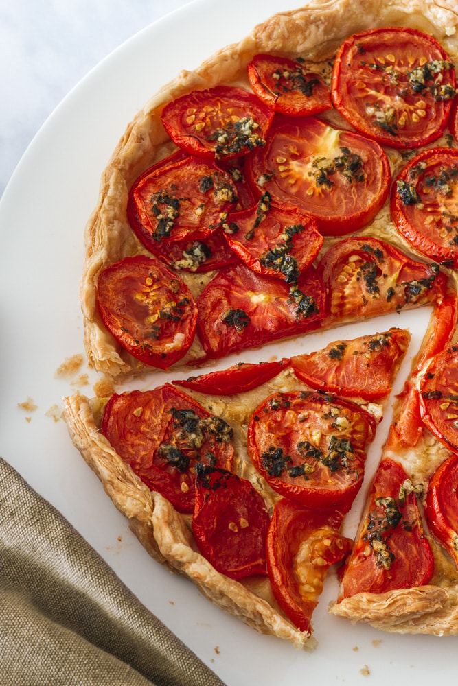A delicious summer time recipe of tomato and mustard tart topped with garlic and parsley.