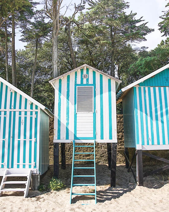 Colourful Blue and White Beach Cabins in Noirmoutier, France.